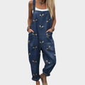 Woman wearing navy overalls with a scattered golden bee print, adjustable straps, cheerful and relaxed.