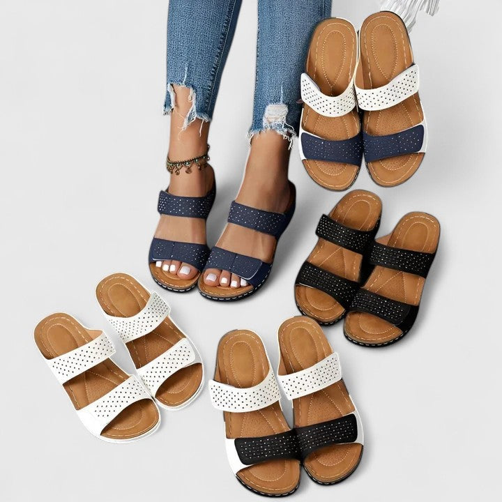 A woman walking comfortably in open-toe wide-fit orthopaedic sandals with a cushioned footbed.