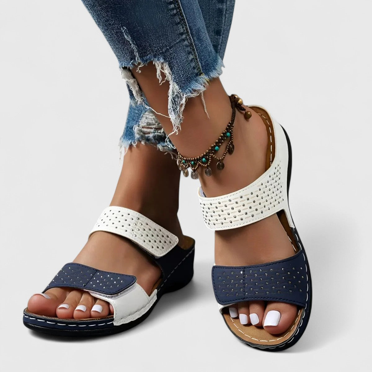 A woman walking confidently in wide-fit comfort sandals with a cushioned, supportive footbed.