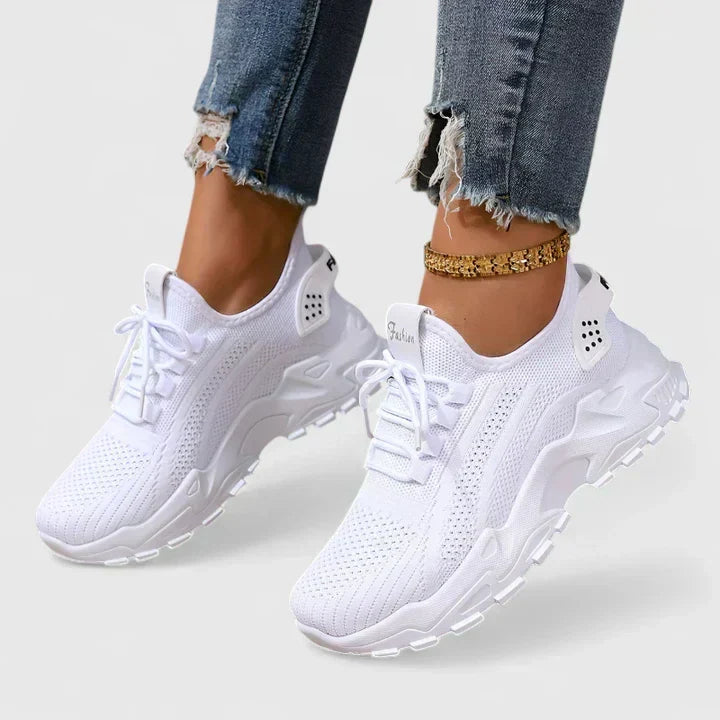 A woman wearing wide-toe cushioned orthopaedic sneakers