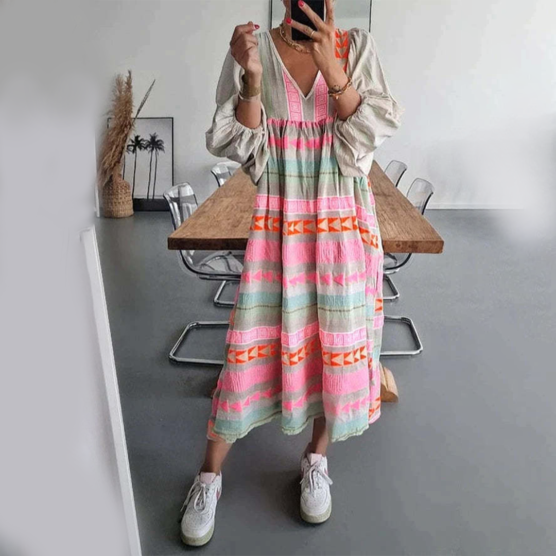 Woman wearing the Holly™ colourful geometric print boho dress with puffed sleeves, out enjoying a casual day.
