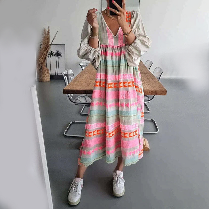 Woman wearing the Holly™ colourful geometric print boho dress with puffed sleeves, out enjoying a casual day.