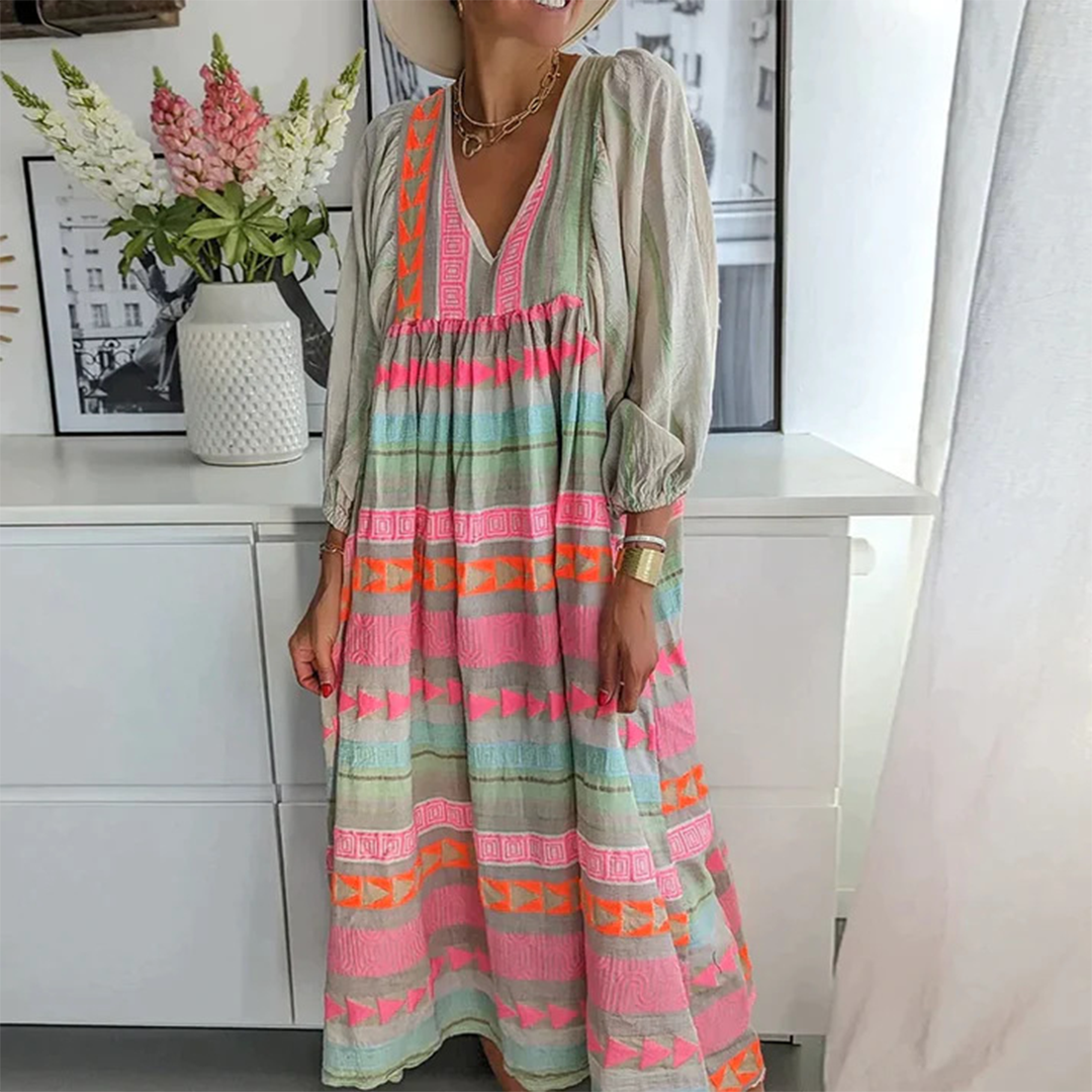 Woman wearing the Holly™ colourful geometric print boho dress with puffed sleeves, out enjoying a casual day.