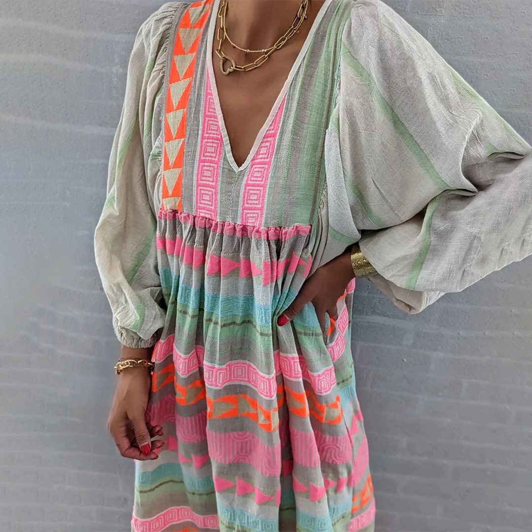 Woman wearing the Holly™ colourful geometric print boho dress with puffed sleeves, out enjoying a casual day.