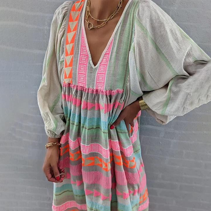 Woman wearing the Holly™ colourful geometric print boho dress with puffed sleeves, out enjoying a casual day.