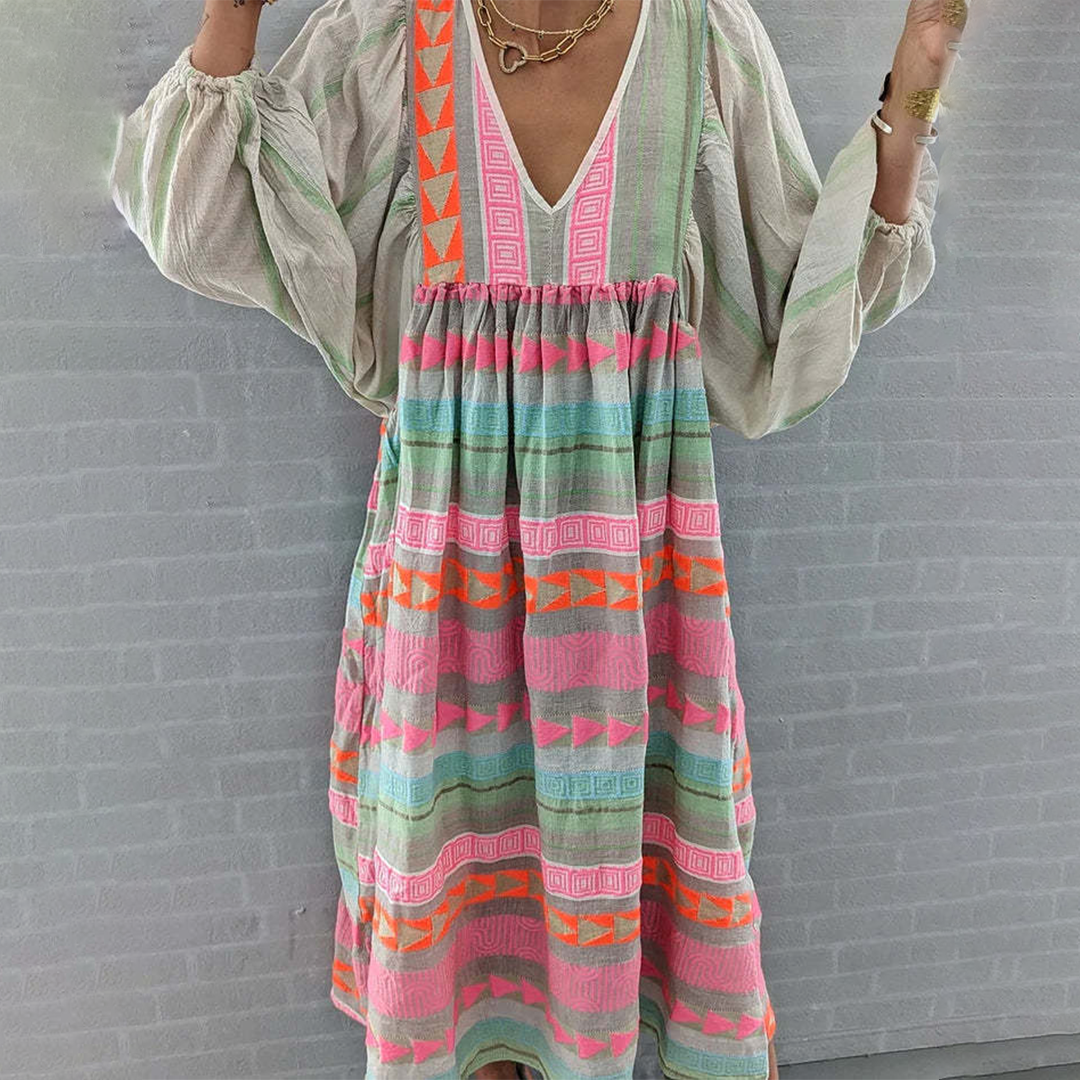 Woman wearing the Holly™ colourful geometric print boho dress with puffed sleeves, out enjoying a casual day.