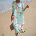 A woman wearing a long, flowing summer dress with an elegant pattern, the hem moving softly as she walks.