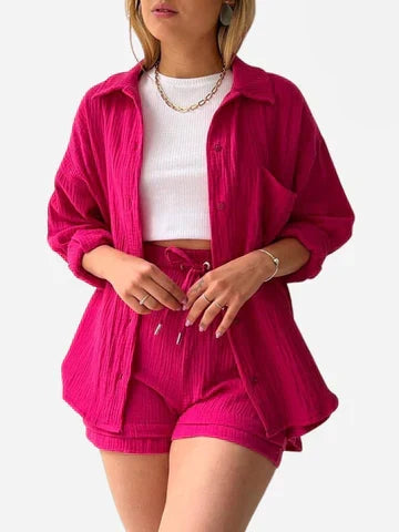 A woman wearing a relaxed button shirt with matching drawstring shorts, fresh and easy.