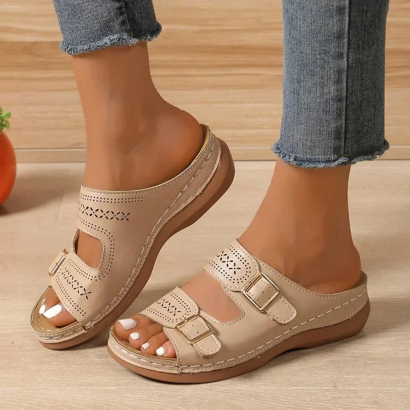 A woman walking with ease in wide-fit adjustable orthopaedic sandals with cushioned soles.