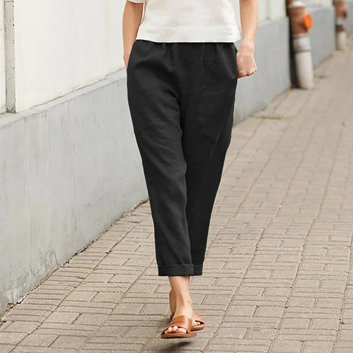A woman wearing wide relaxed pants with two roomy pockets and an elastic waist.