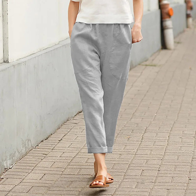 A woman wearing wide relaxed pants with two roomy pockets and an elastic waist.