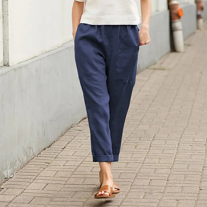 A woman wearing wide relaxed pants with two roomy pockets and an elastic waist.
