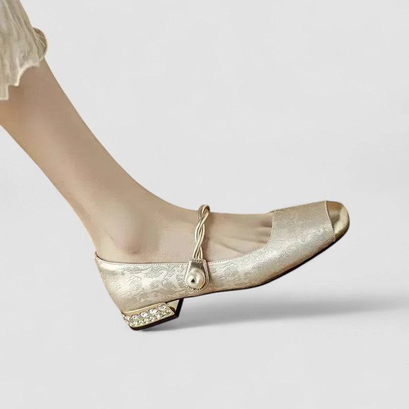 A woman in sparkling Mary Jane shoes with a low block heel at an evening celebration.