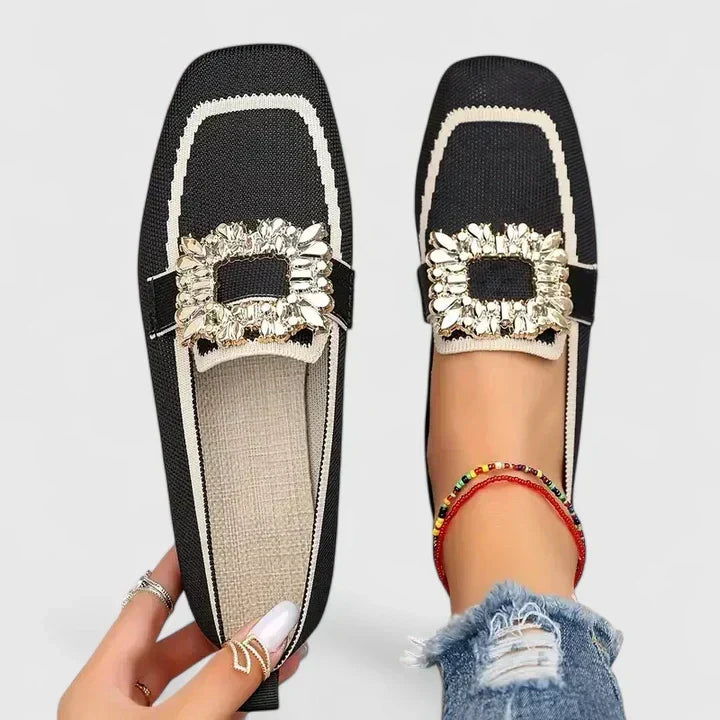 A woman wearing embellished comfort flats with a sparkling jewelled square buckle