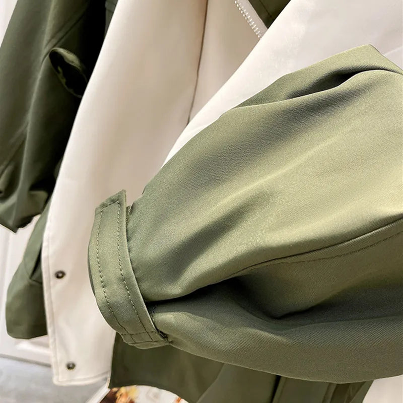 A woman wearing a lightweight weatherproof jacket with an adjustable hem on a blustery day.