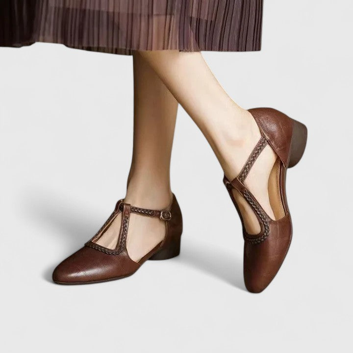 A woman wearing beige T-strap flats, dressed for a special occasion.
