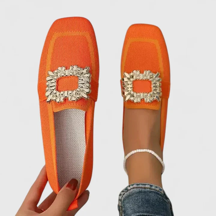 A woman wearing embellished comfort flats with a sparkling jewelled square buckle