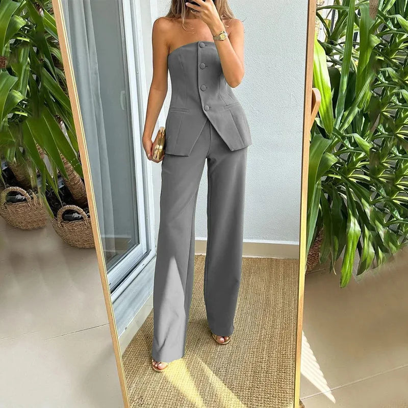 A woman wearing a tailored sleeveless button-detail top with matching wide-leg pants.