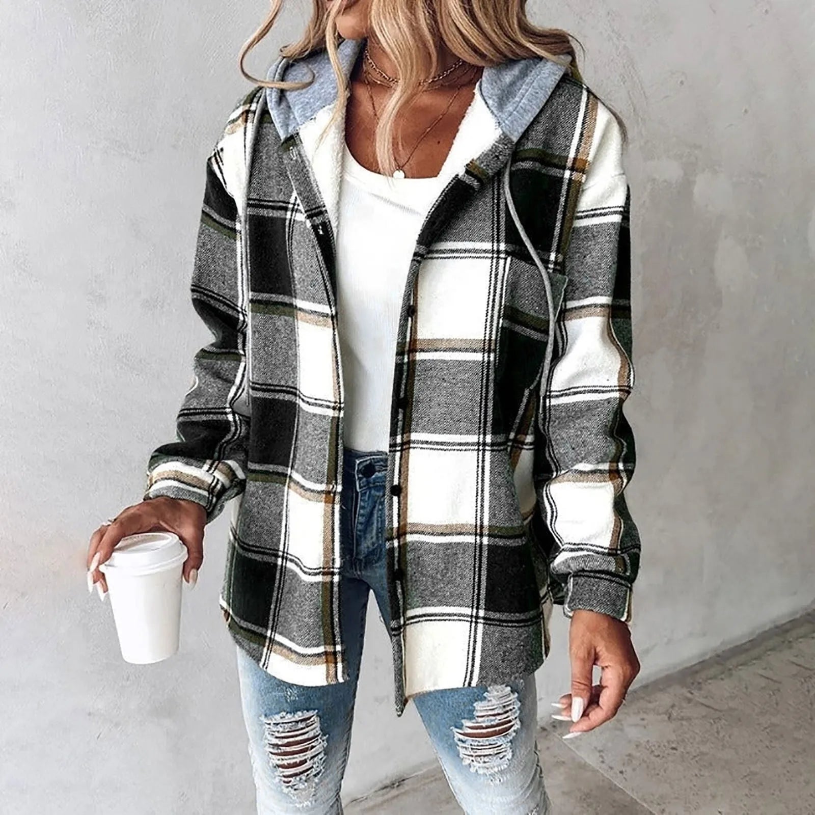 A woman wearing a grey and white checked hooded jacket with a button front