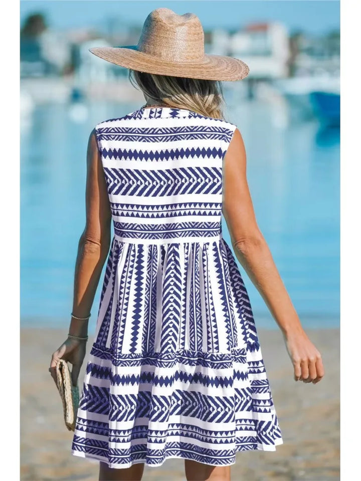Woman in a geometric print A-line summer dress enjoying a sunny day out.