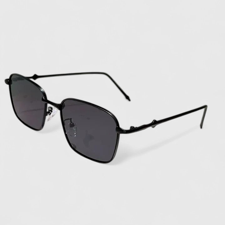 A woman on a sunny street wearing classic square gradient sunglasses, confident and stylish.
