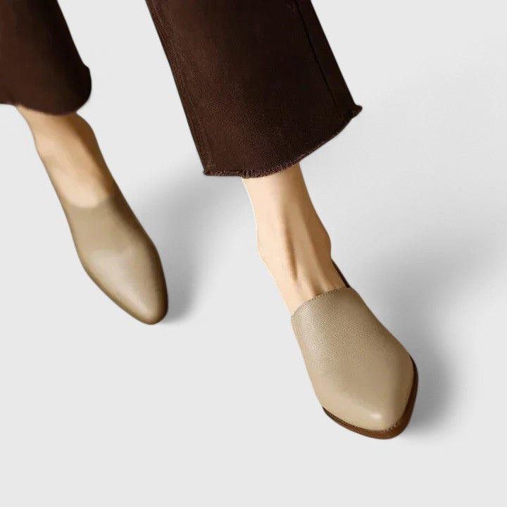 Woman wearing apricot comfort support shoes, walking through a busy market.