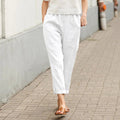A woman wearing wide relaxed pants with two roomy pockets and an elastic waist.