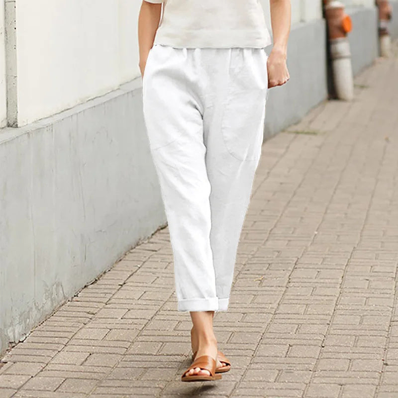 A woman wearing wide relaxed pants with two roomy pockets and an elastic waist.