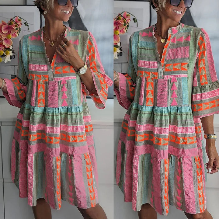 Woman wearing a flared spring mini dress with delicate ruffles and a V-neckline.