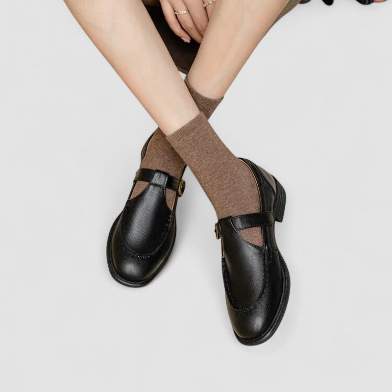 A woman in black round-toe Mary Jane shoes, comfortable and classic at the office.