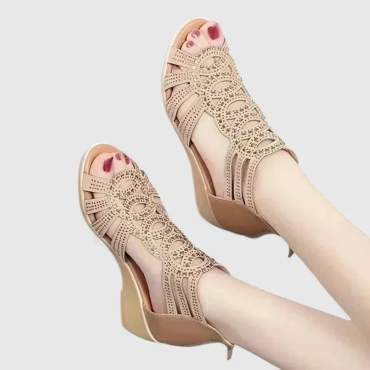 A woman's black caged wedge sandals with sparkle detail, an open toe and a back zip.