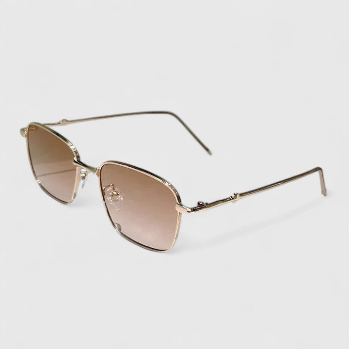 A woman on a sunny street wearing classic square gradient sunglasses, confident and stylish.