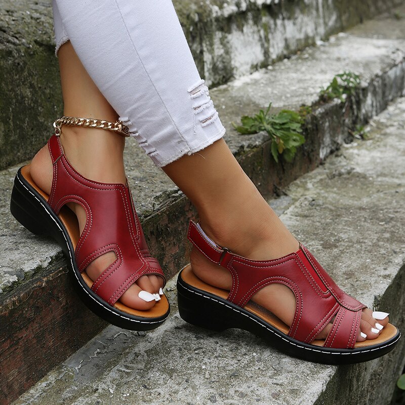 A woman wearing supportive heeled sandals with a summer dress, walking comfortably and looking relaxed.