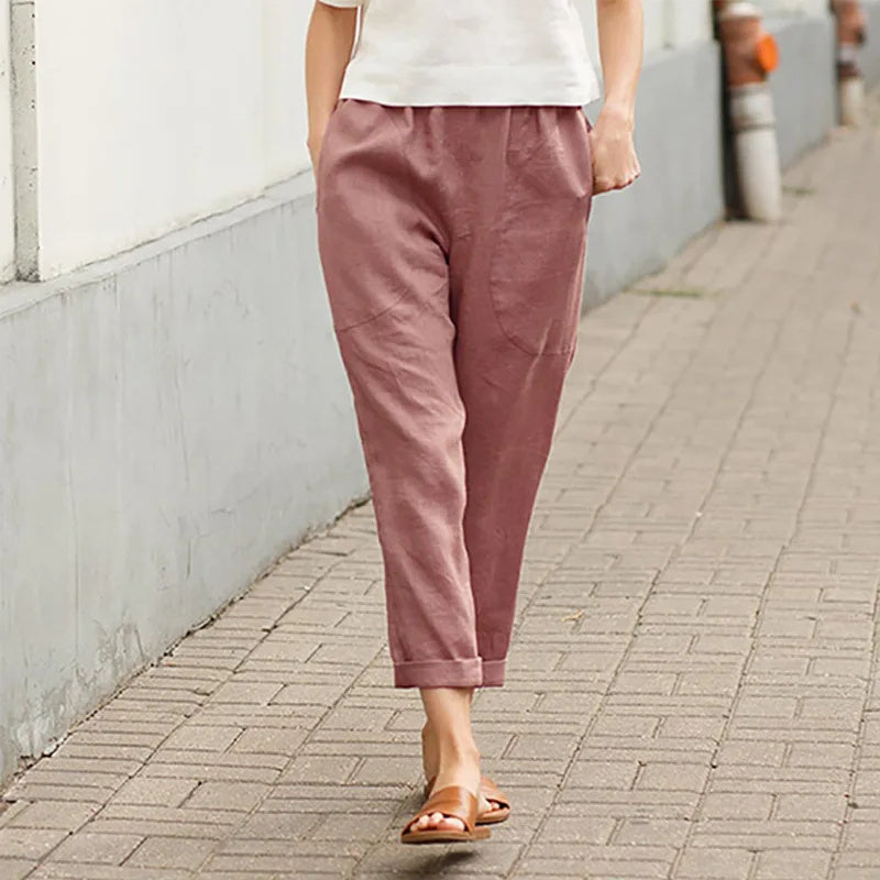A woman wearing wide relaxed pants with two roomy pockets and an elastic waist.