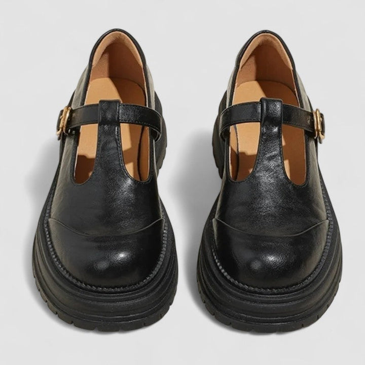 A woman wearing brown T-strap Mary Jane shoes, comfortable on a day around town.