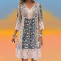 A woman wearing the Cindy romantic boho midi dress with scalloped trim and a floral patchwork print.
