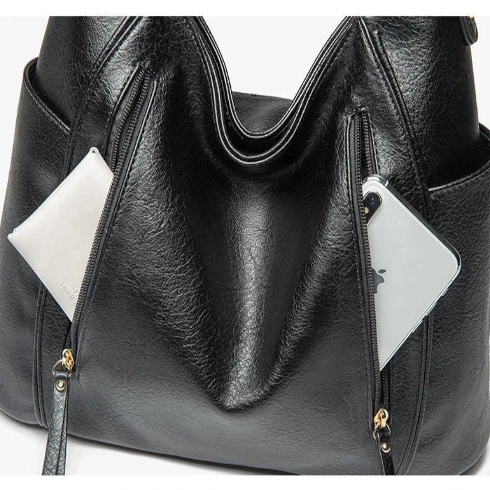 A woman carrying an elegant luxury shoulder bag with a rich finish