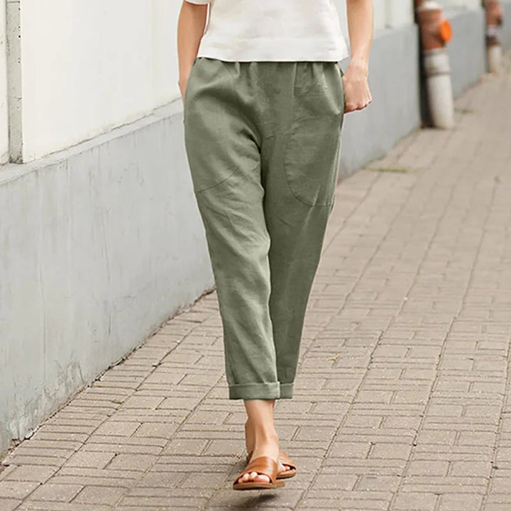 A woman wearing wide relaxed pants with two roomy pockets and an elastic waist.
