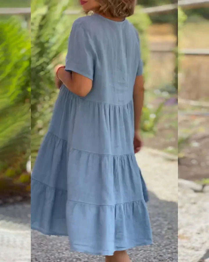 Woman wearing the Bonnie™ V-neck summer dress with a soft layered skirt, strolling on a sunny afternoon.