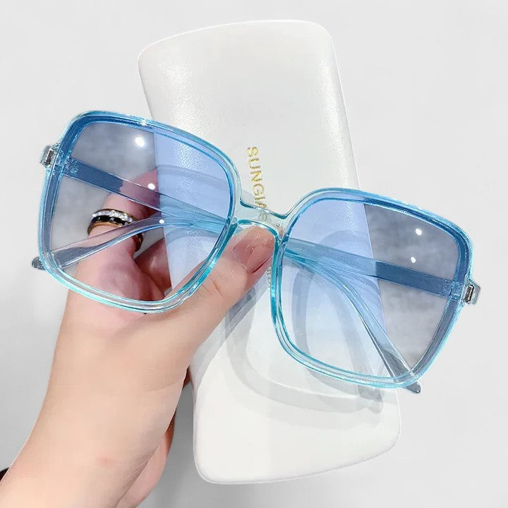 A woman running errands in town wearing classic square sunglasses, calm and stylish.