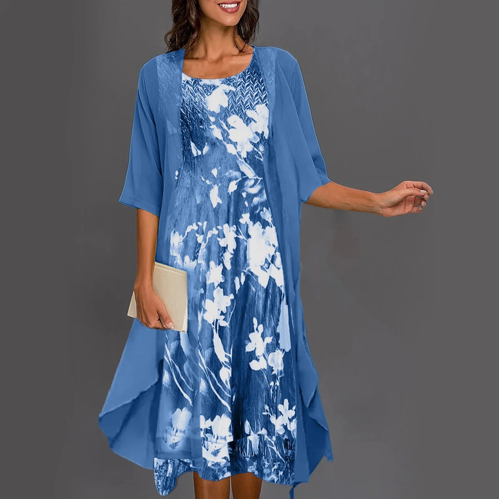 A woman wearing a flowing layered dress set with a printed inner dress, graceful and elegant.