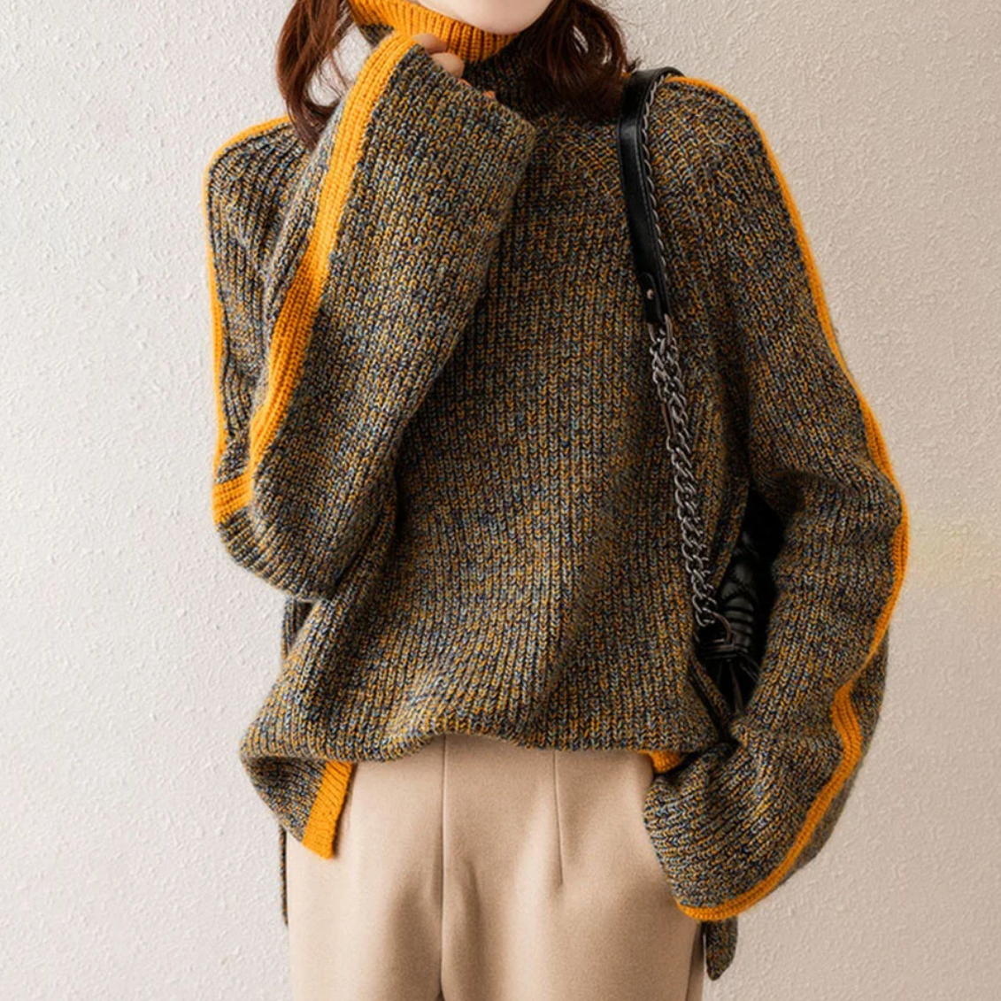 A woman wearing a softly textured everyday sweater with a relaxed modern line.