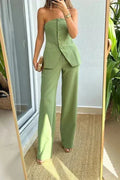 A woman wearing a tailored sleeveless button-detail top with matching wide-leg pants.