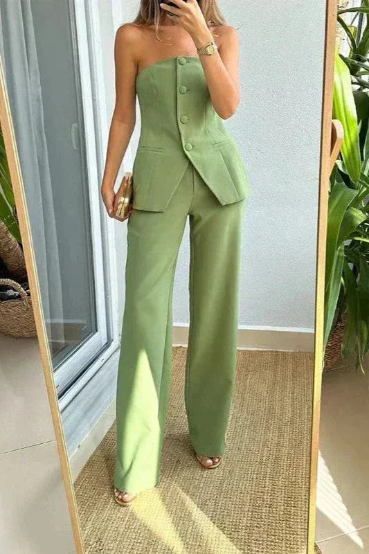 A woman wearing a tailored sleeveless button-detail top with matching wide-leg pants.
