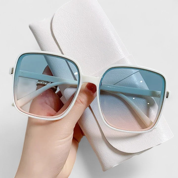 A woman running errands in town wearing classic square sunglasses, calm and stylish.