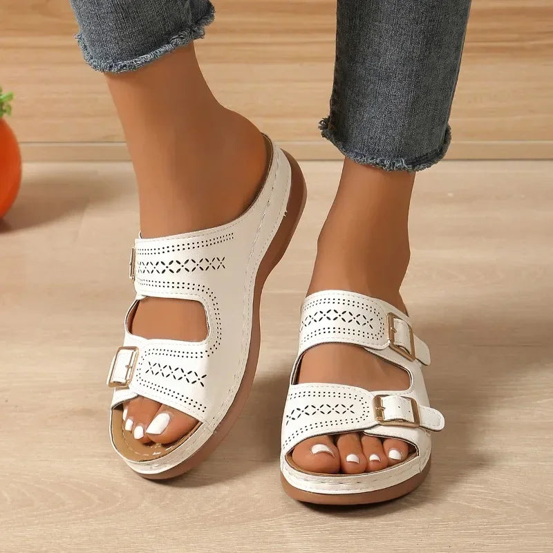 A woman walking with ease in wide-fit adjustable orthopaedic sandals with cushioned soles.
