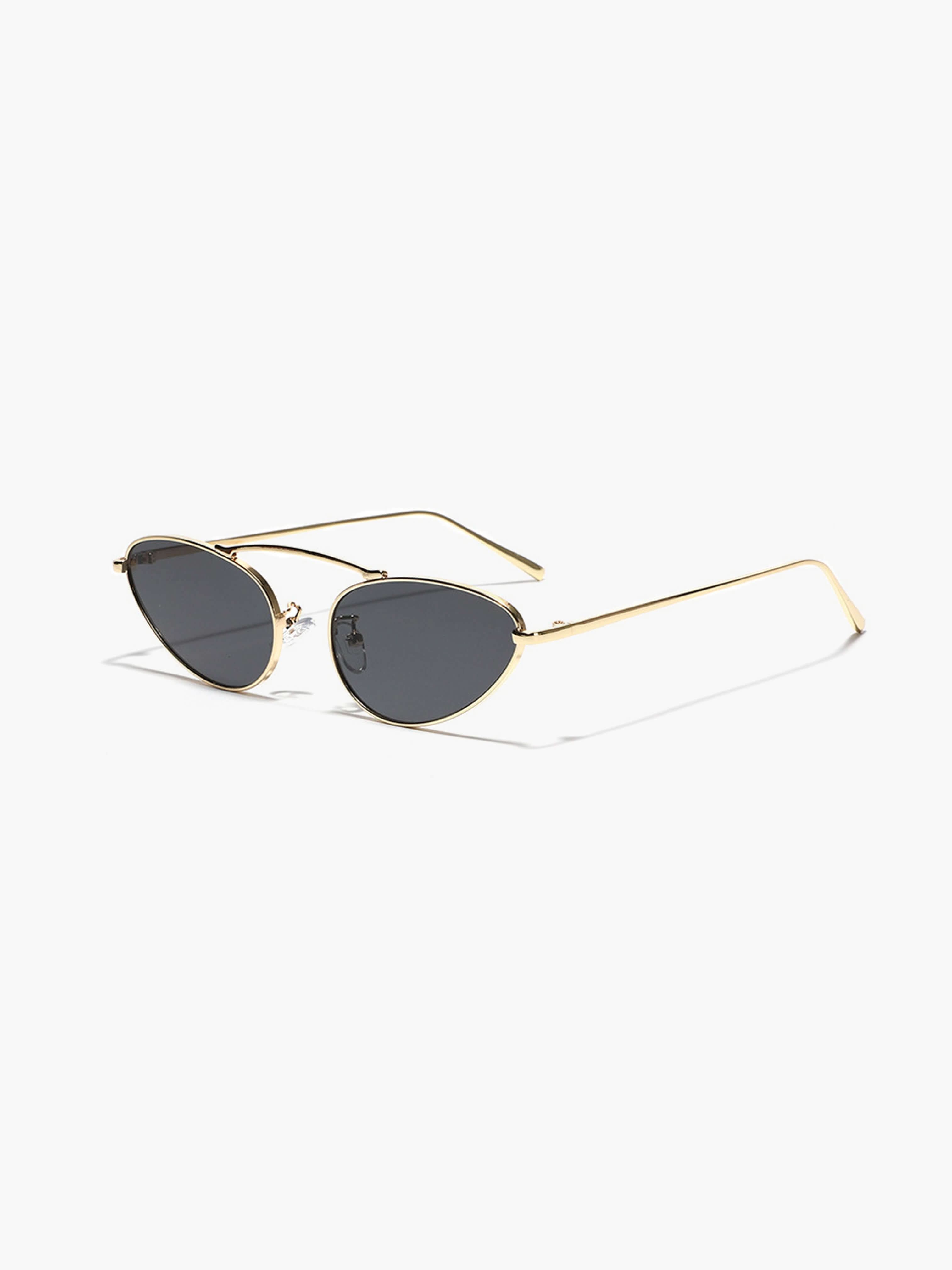 A woman wearing timeless slim black cat-eye sunglasses on an fall day.