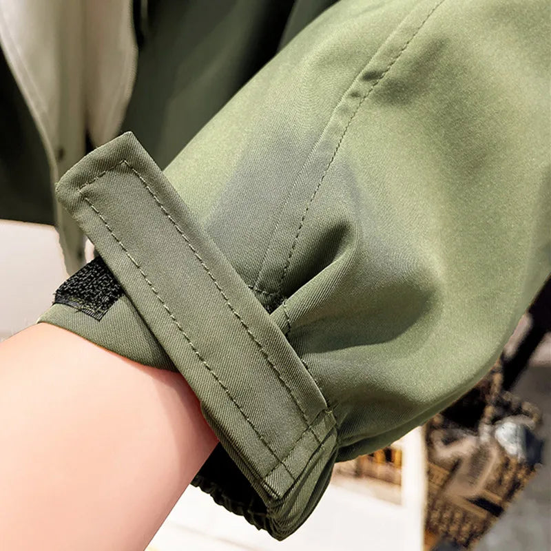 A woman wearing a lightweight weatherproof jacket with an adjustable hem on a blustery day.