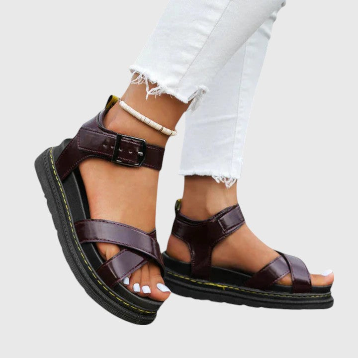 A woman walking confidently in elegant wide-fit orthopaedic sandals with buckle straps.