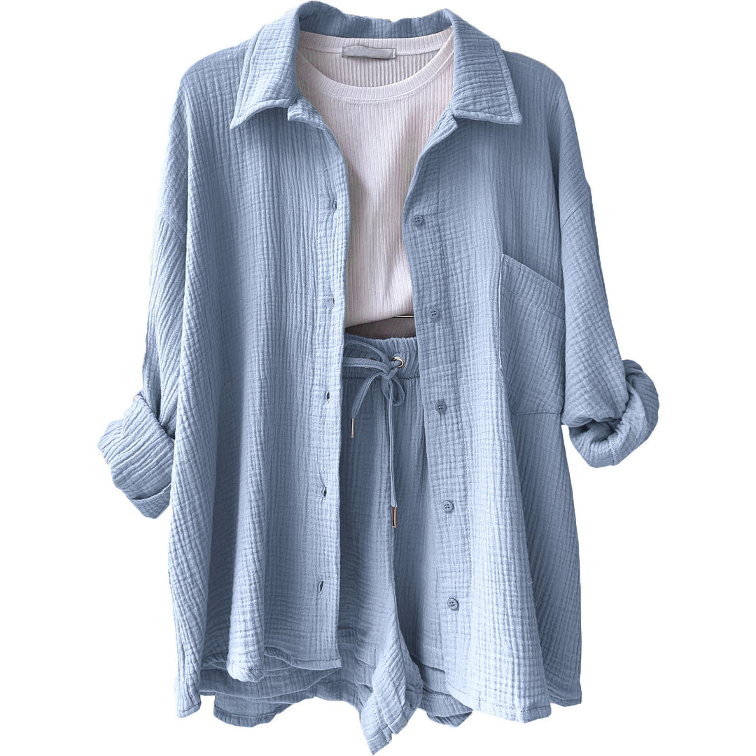 A woman wearing a relaxed button shirt with matching drawstring shorts, fresh and easy.